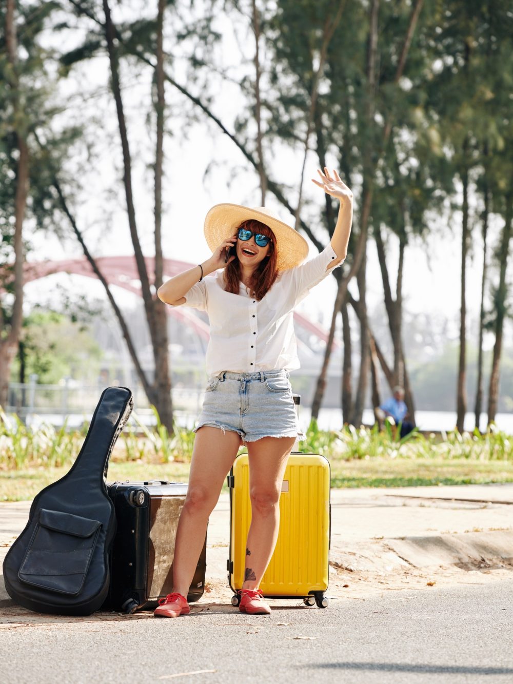 female traveler hailing a taxi with luggage bradford